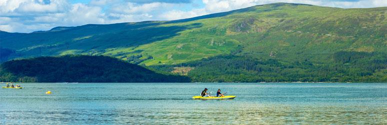 Couple on a canoe on calm blue Loch Lomond