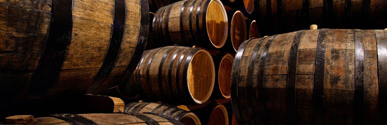 Whiskey barrels stacked in distillery