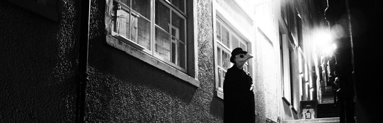 Man wearing plague mask on the dark streets of Edinburgh