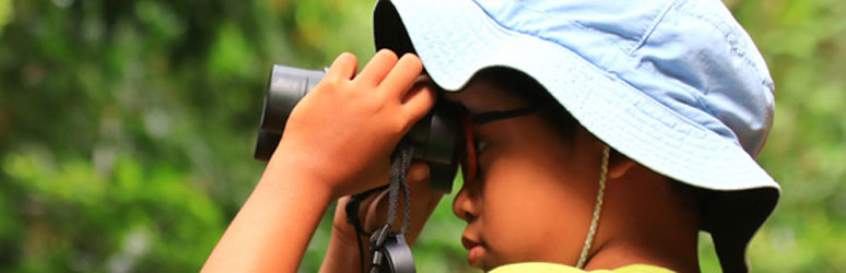 Kid looking through binoculars