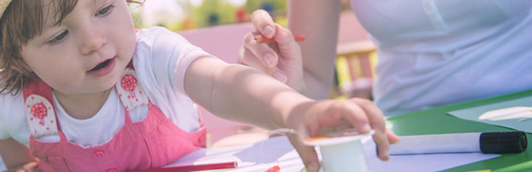 Girl doing arts and crafts outside