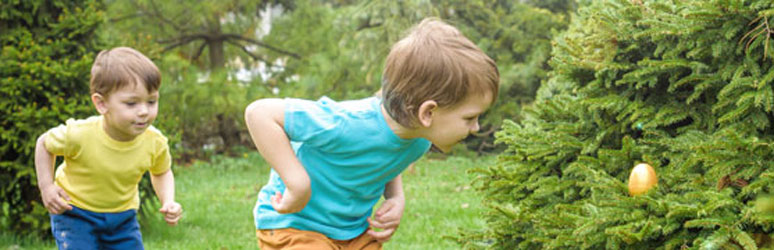 Kids hunting for easter eggs in garden