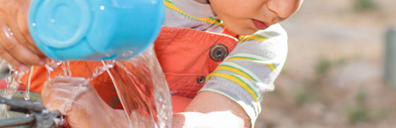 Kid playing with water outdoors