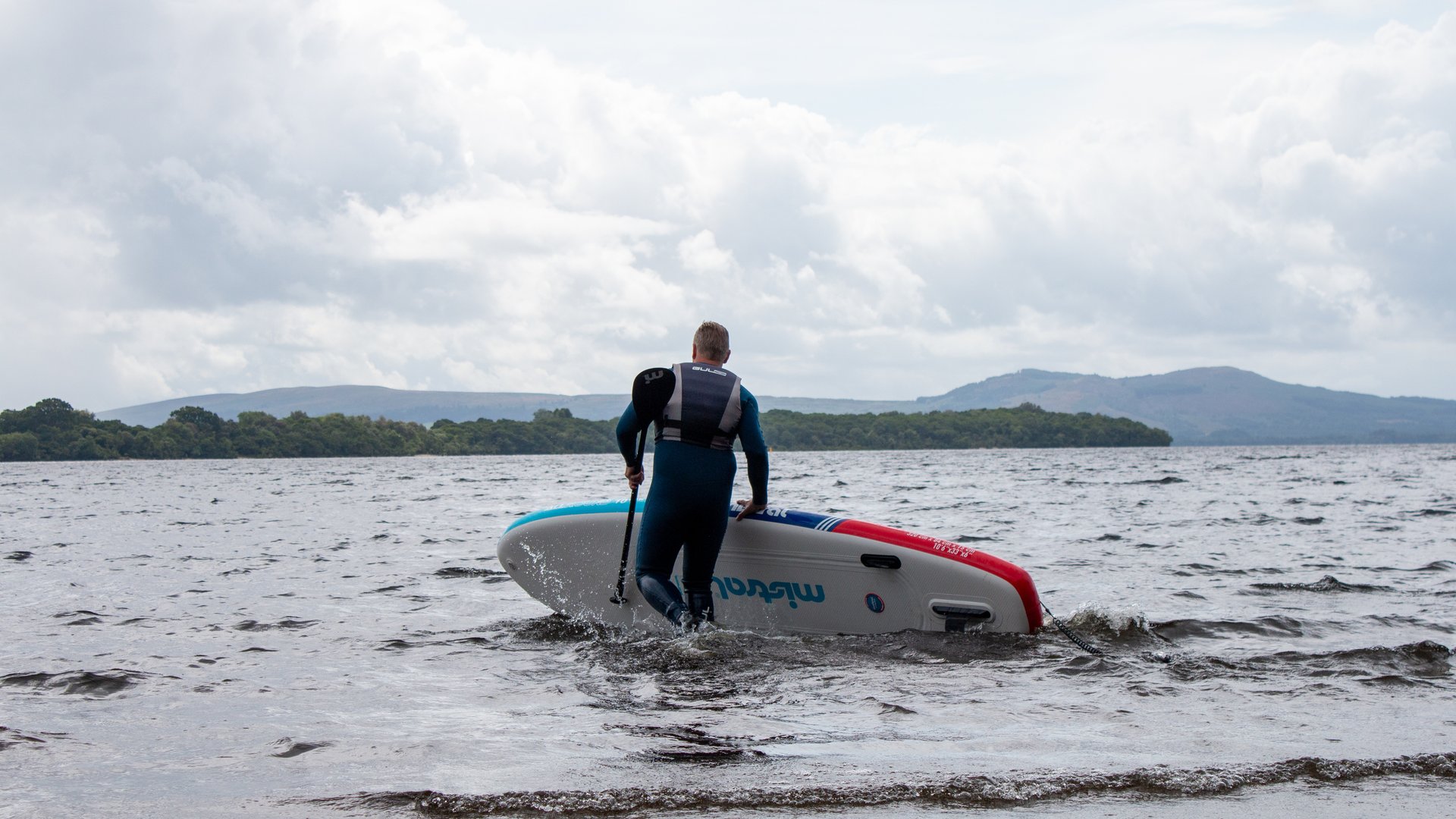 Man carrying paddleboard