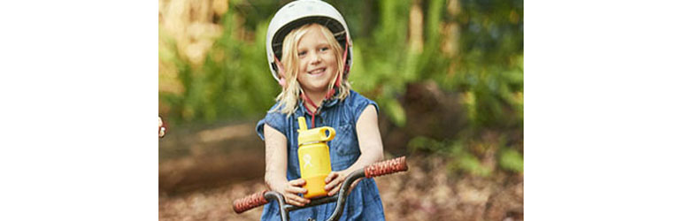 girl holding a flask of drink on her bike