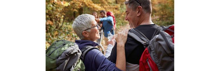 two walkers looking at each other in the woods