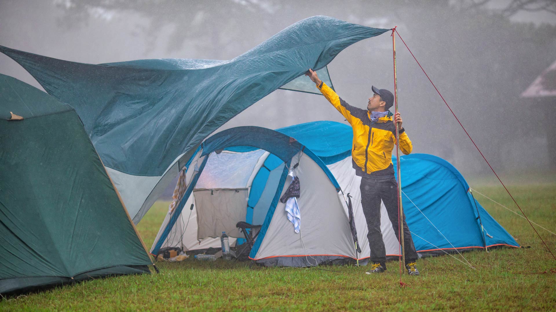 Putting up a tent in the rain