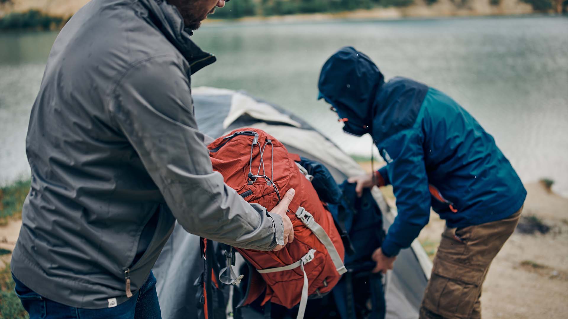 Men putting bags in tent