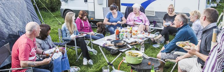 Campers sat around enjoying a meal