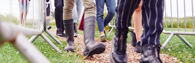 People at a festival wearing wellies