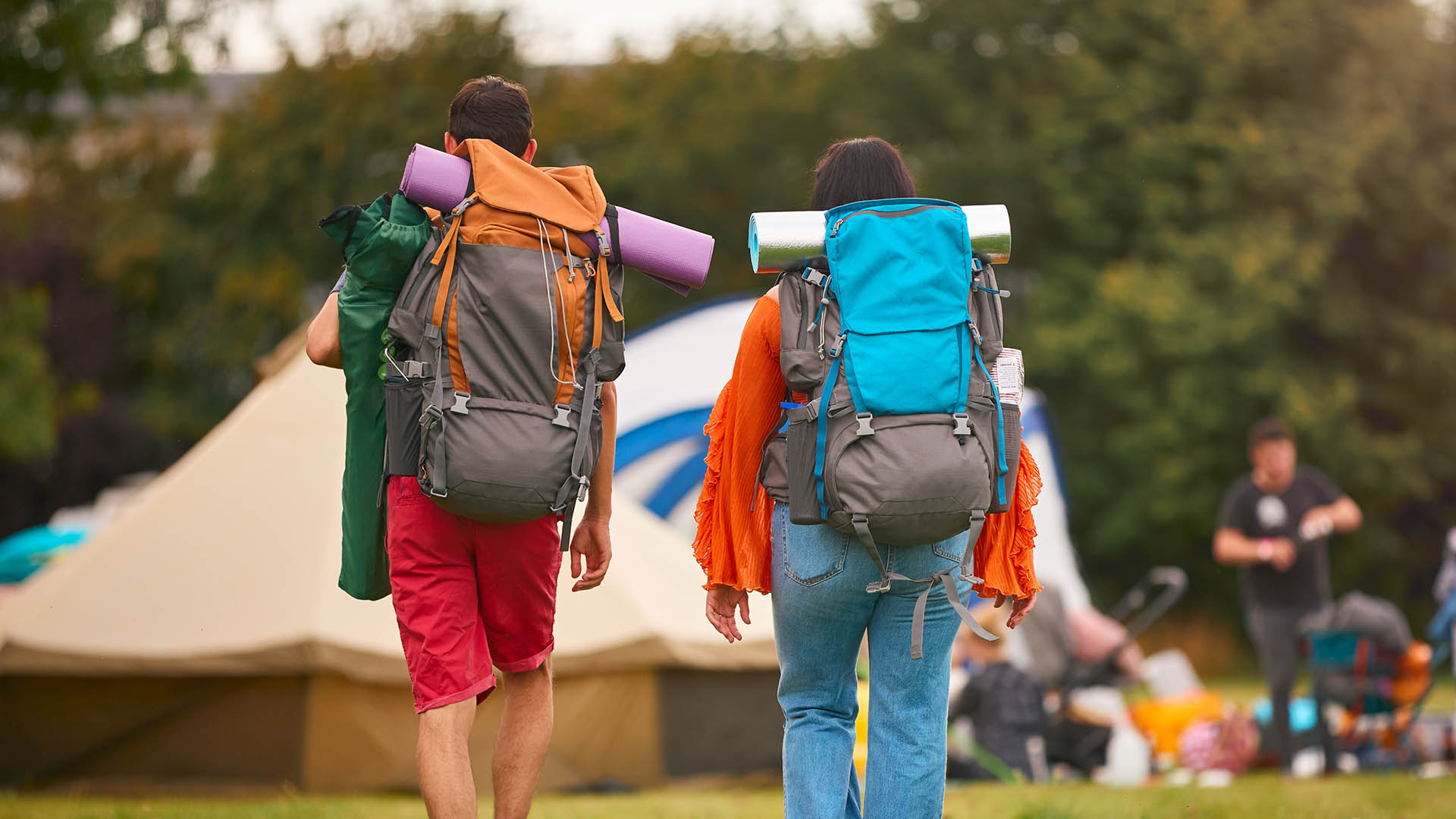 Couple walking towards tent