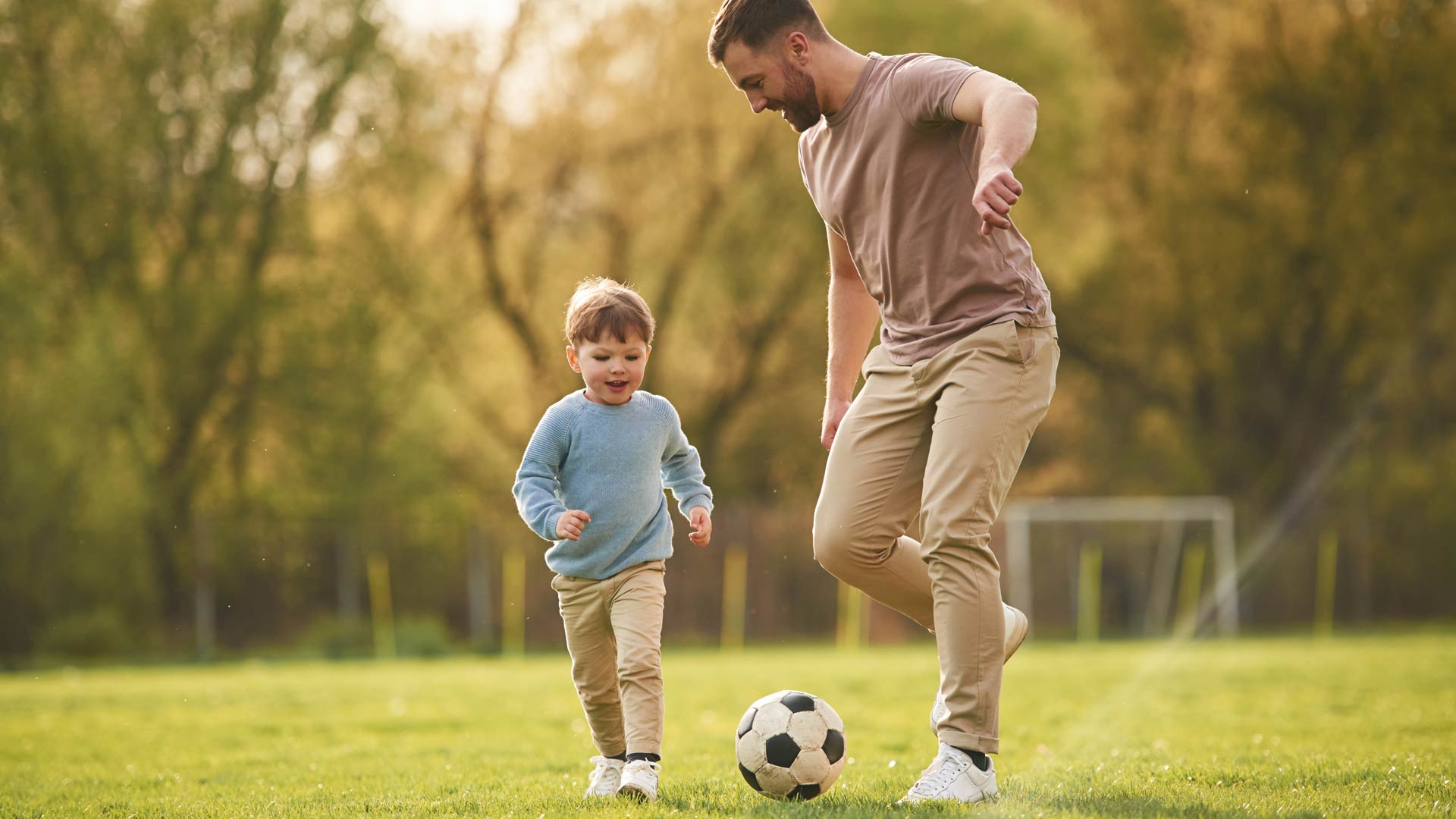 Father and son playing football 