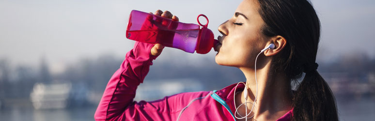 Woman drinking from water bottle