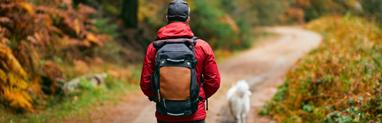 Backpacker walking dog