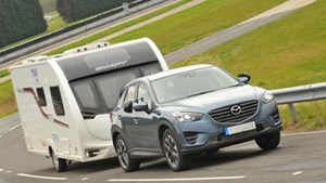 Grey car towing a caravan