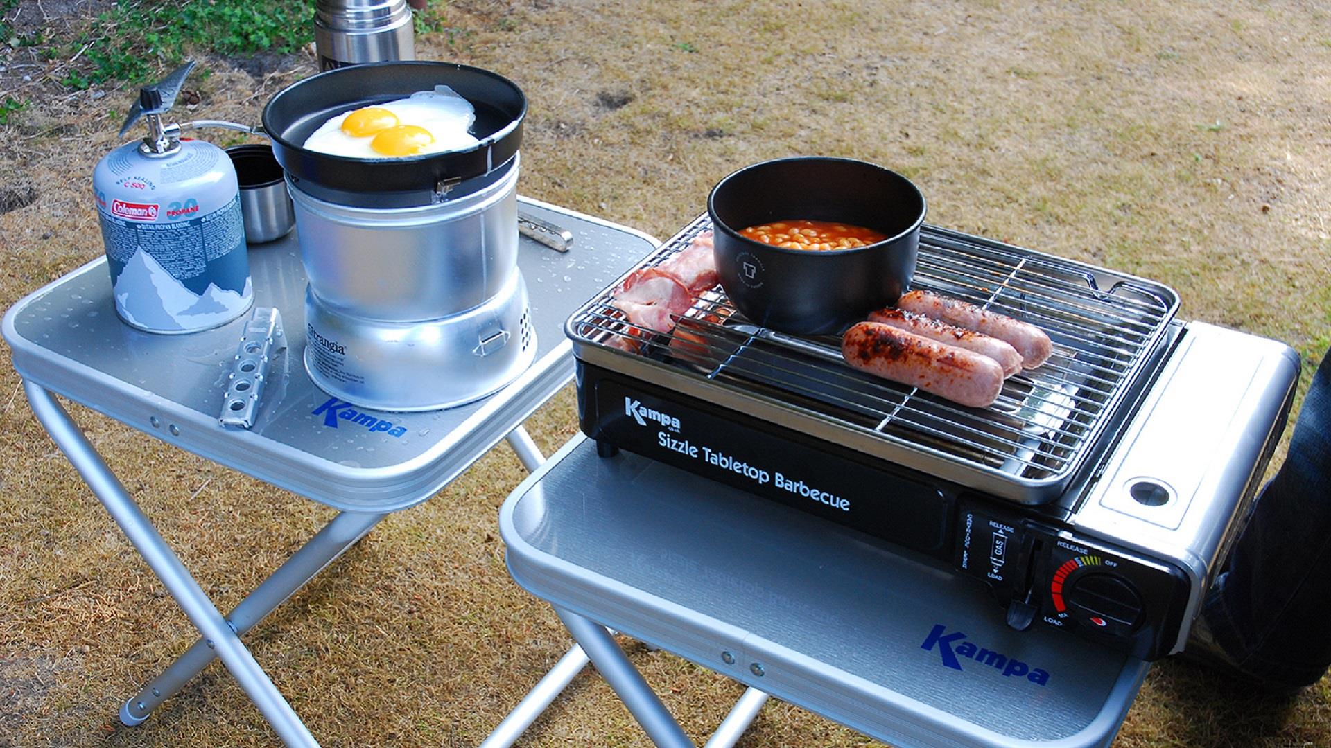 Full English breakfast cooking on a camping stove