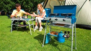 Two teenagers sat enjoying bbq food