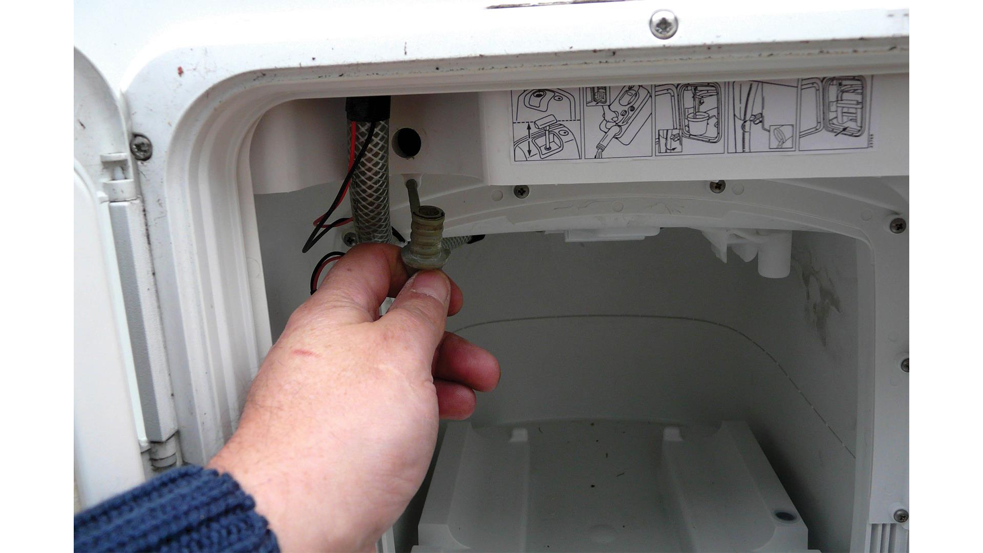 Draining toilet flush tank. 
