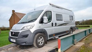 Large grey vehicle using a public weighbridge