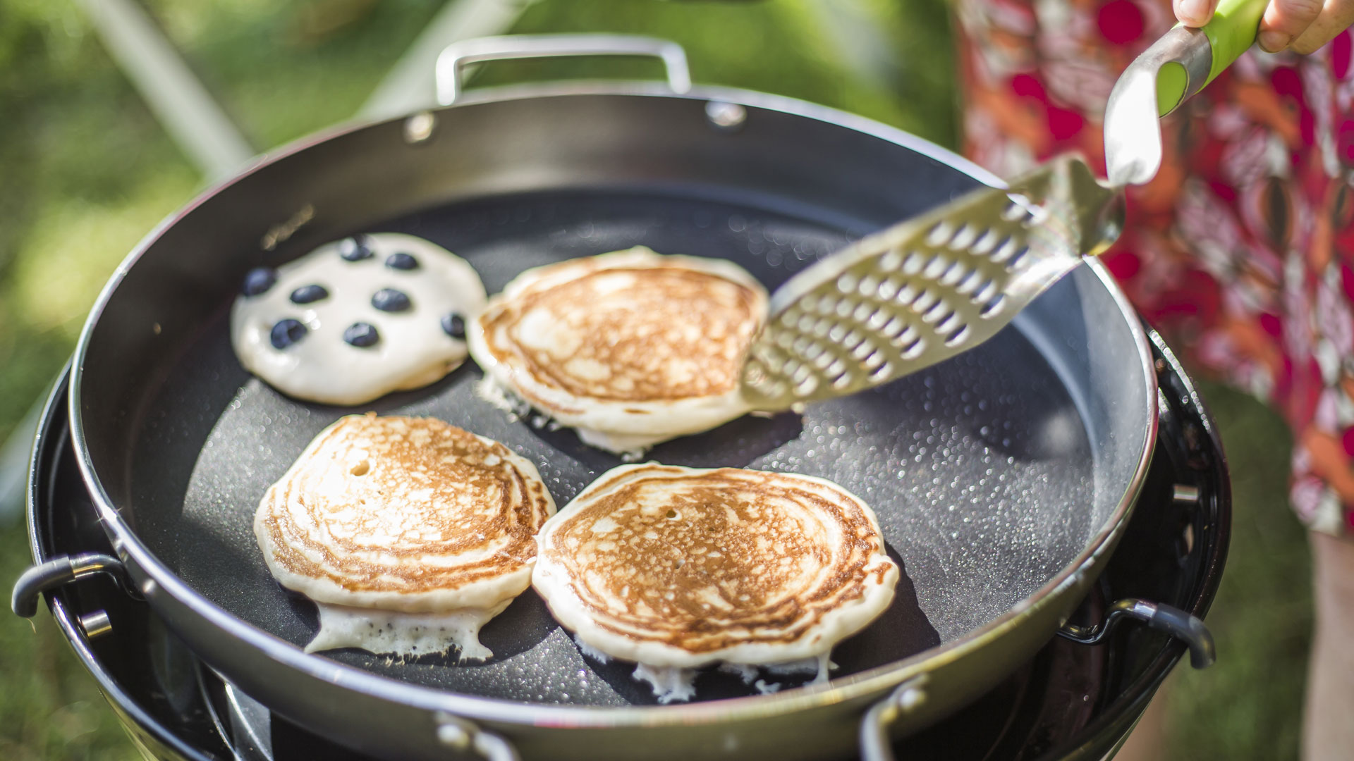 Blueberry pankcakes being cooked on camping stove