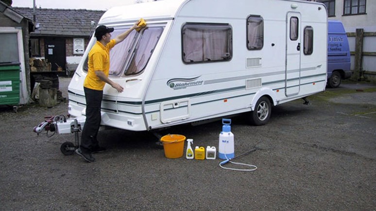 Man cleaning a caravan