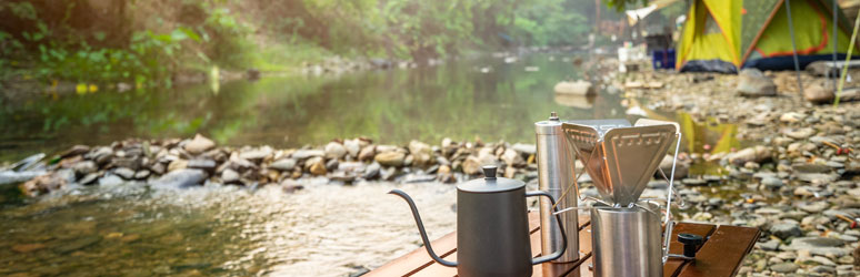 Camping equipment set up by a stream of water
