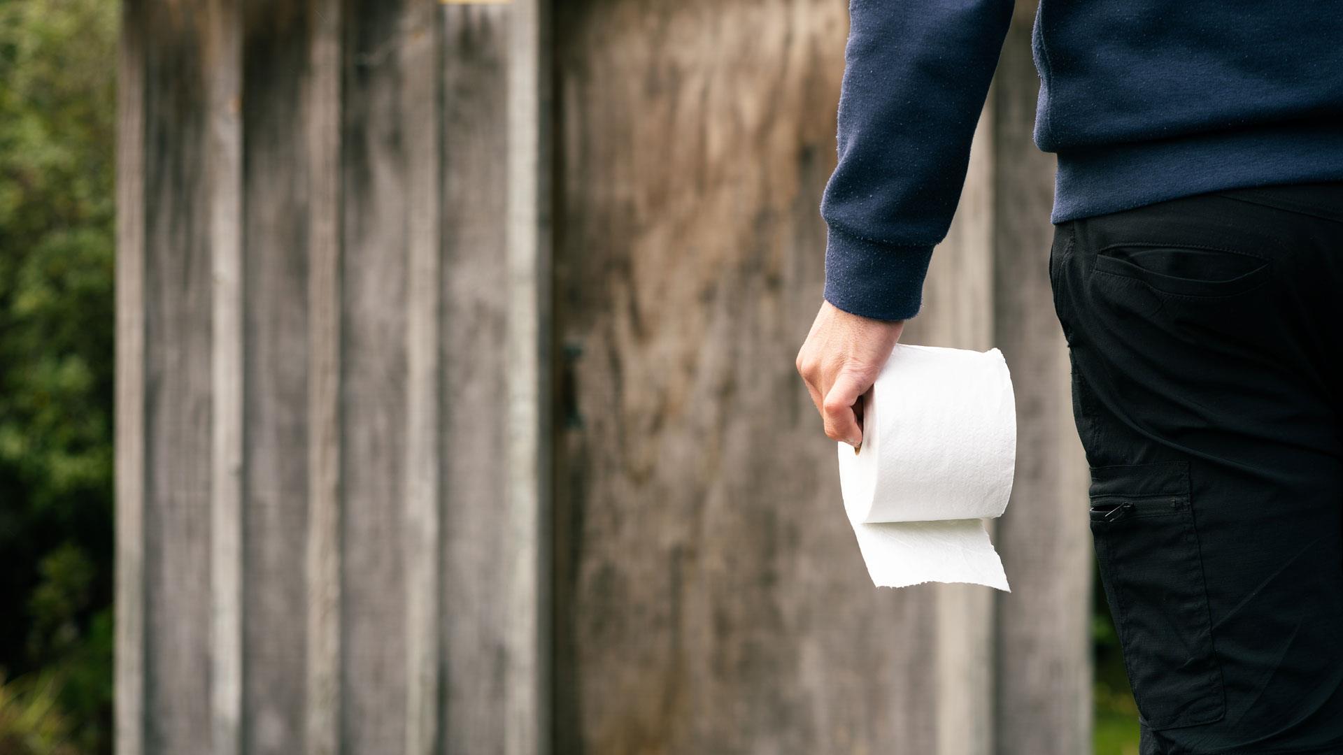Man walking to camping toilet