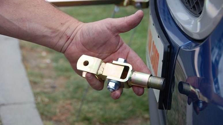 A-frame connectors being fitted to the front of a car to be towed (courtesy Smart Tow)