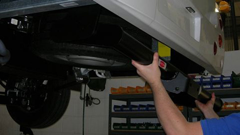 A towbar being fitted to a motorhome
