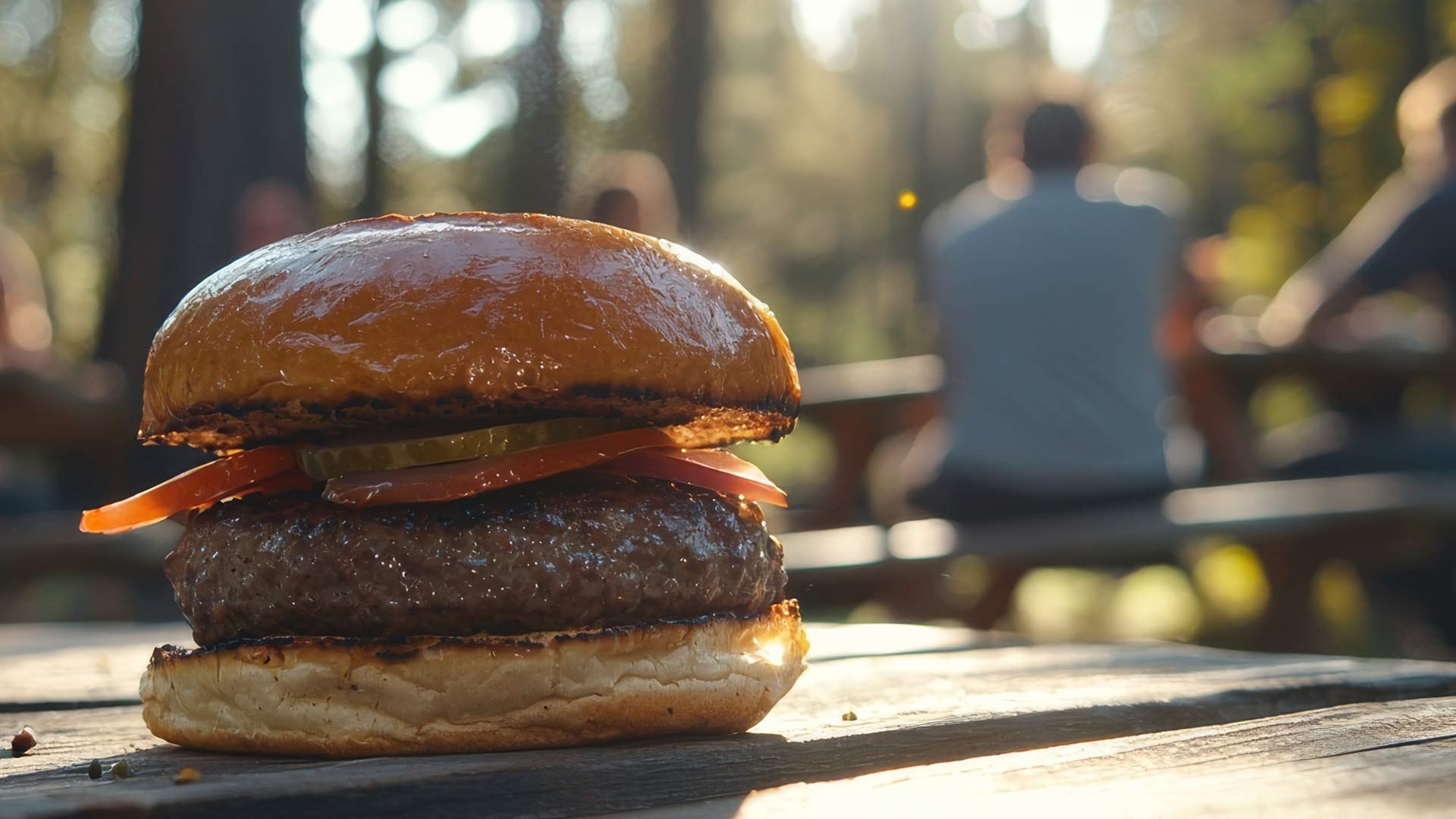 four burgers being cooked