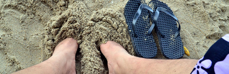 Feet buried in the sand