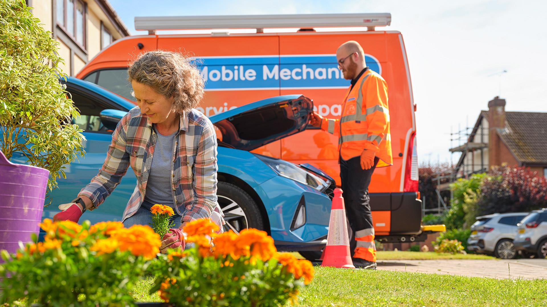 A woman kneels to tend flowers while an RAC mobile mechanic checks under the bonnet of a blue car, with an RAC van parked in the background.