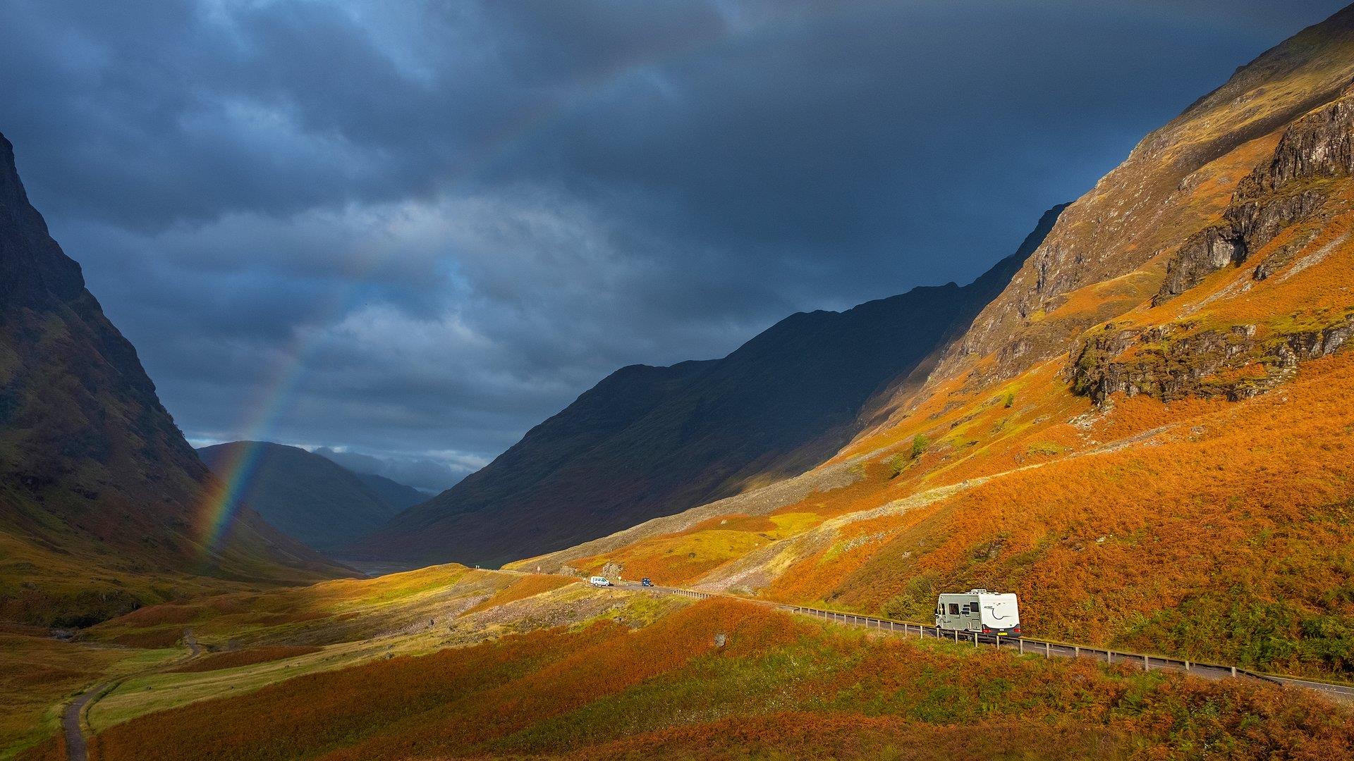 Campervan in the distance making its way long a mountainous road