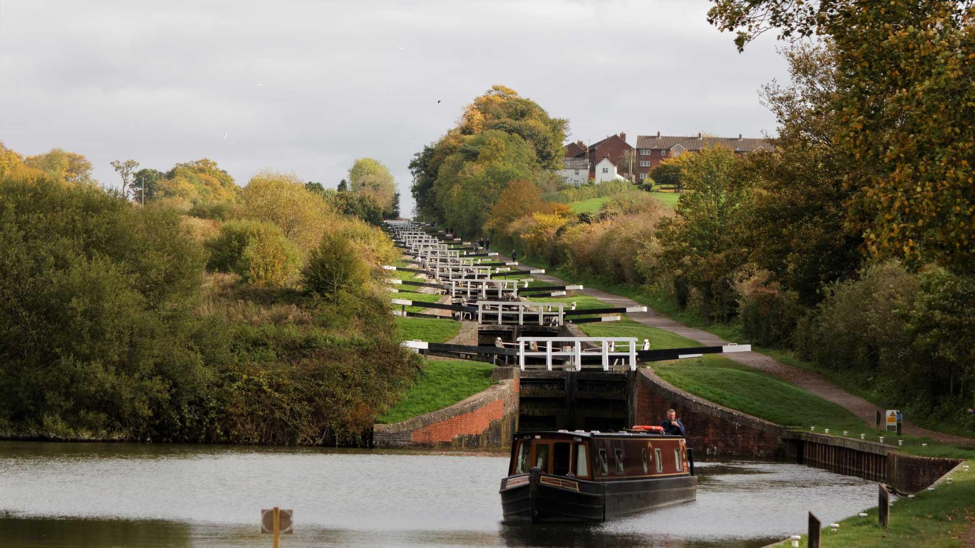 A canal barge at the bottom of a flight of locks