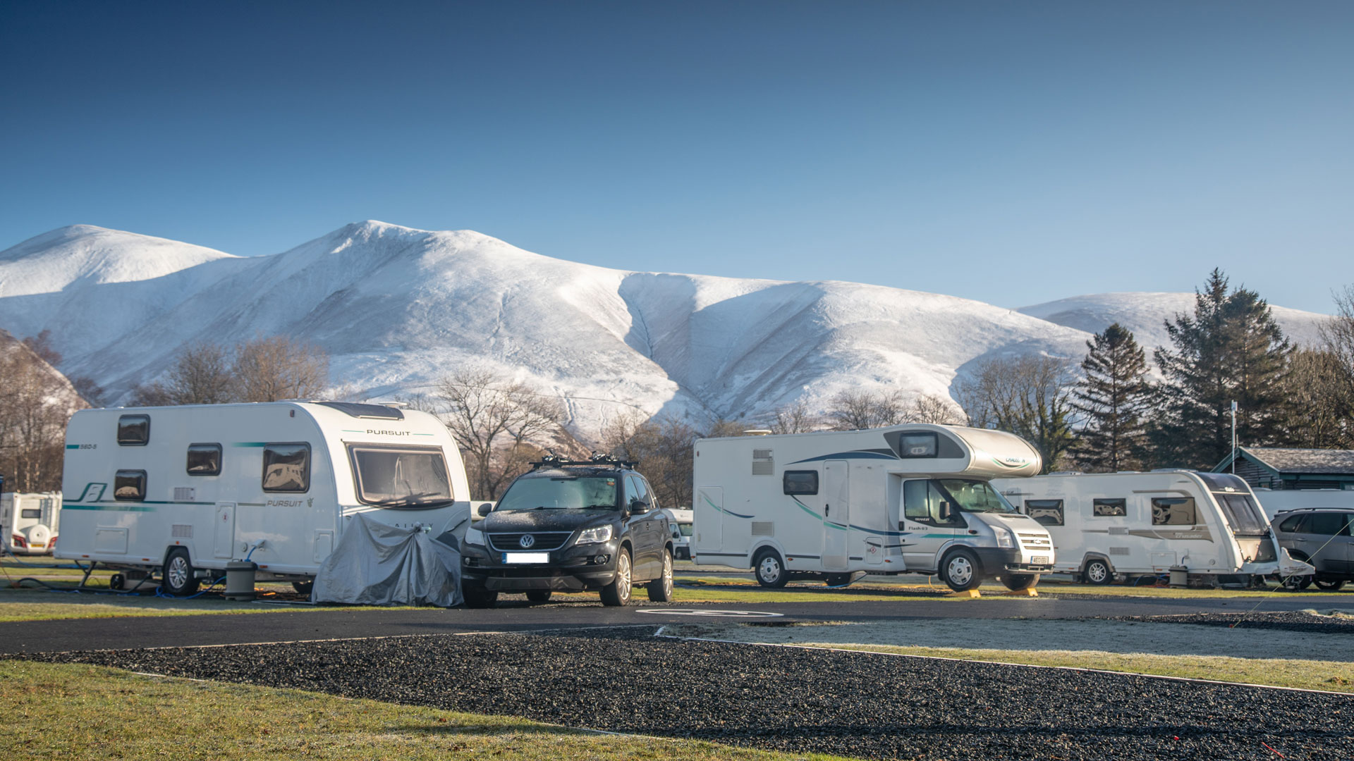 Winter campsite surrounded by snow capped mountains in Scotland