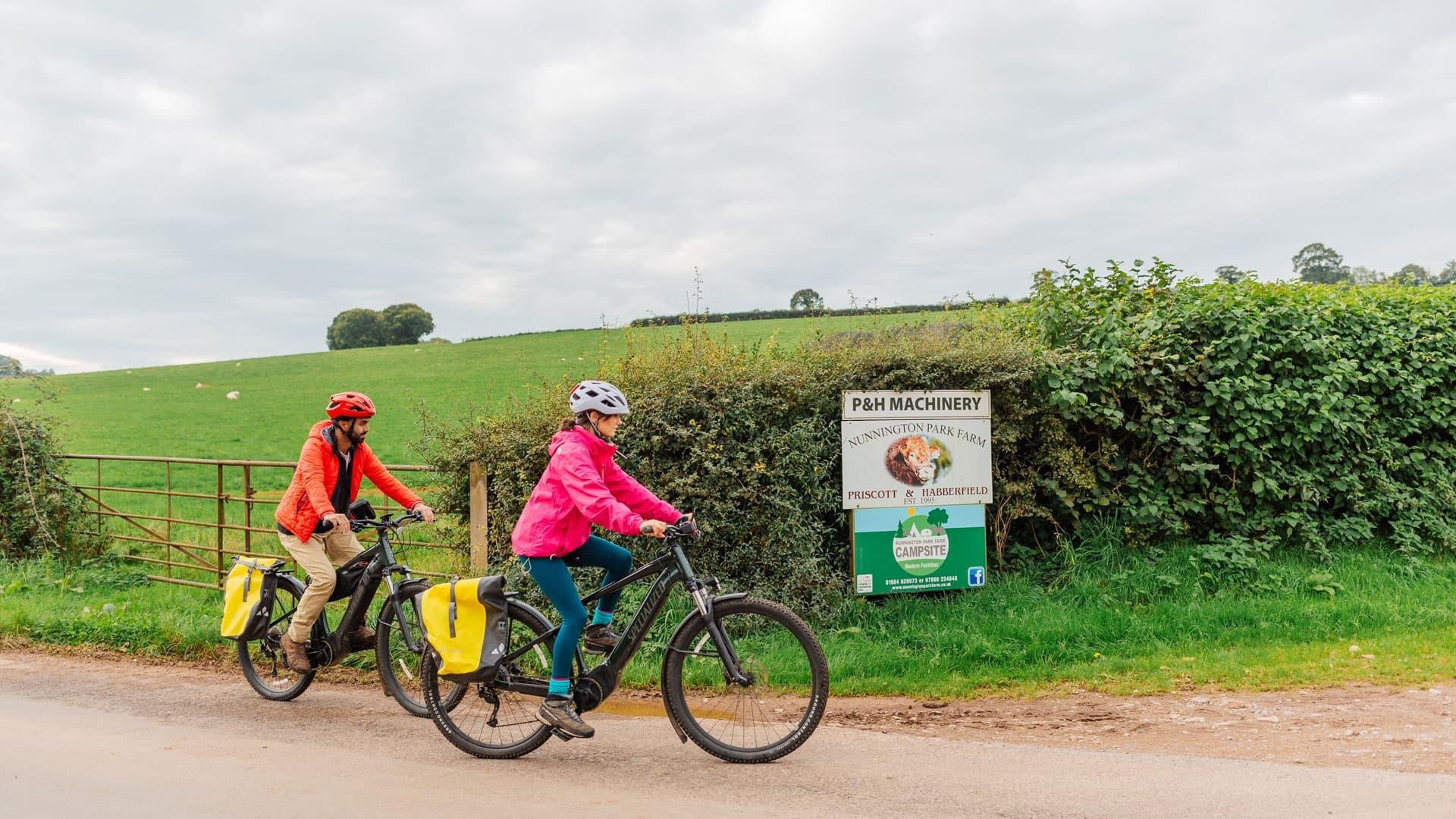 Two cyclists entering Nunnington Park Farm Campsite