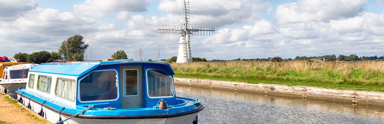 Blue canal boat on the Norfolk Broads