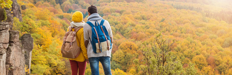 Couple with backpacks on autumn hike